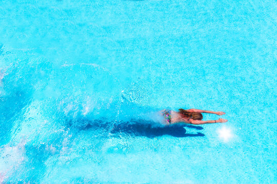 Woman diving underwater in swimming pool