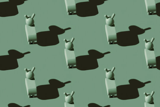 Pattern of small green donkey figurines against pastel green background