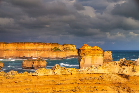Scenic view of The Razorback by sea at Bay of Islands Coastal Park against cloudy sky, Victoria, Australia