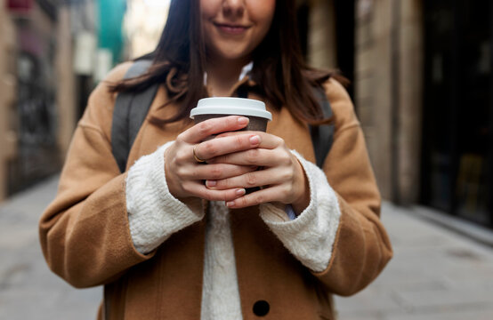 Close-up of young woman with takeaway coffee in the city, Barcelona, Spain