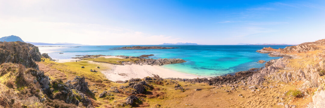 Panoramic shot of Smirisary Beach while The Small Isles of Rum, Eigg and Muck in background, Smirisary Beach, Lochailort, Scotland, UK