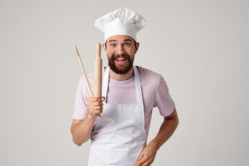 bearded man chef kitchenware cooking restaurant light background