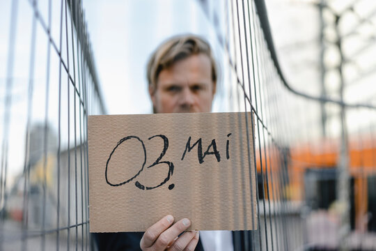 Businessman holding cardboard with a date