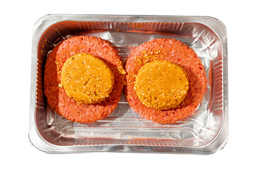 Two big size fresh beef burgers with smoky barbeque cheese melt on top in a foil tray on white background. Meat industry product for cooking home. Premium top quality hamburger.