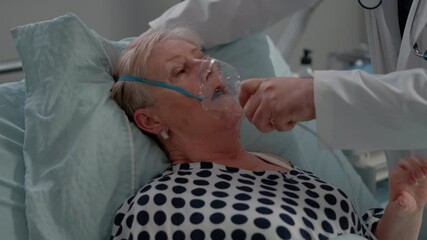Sick patient breathing heavily while doctor giving help with oxygen mask for respiratory problem. Medic and nurse helping senior woman with medical equipment for healthcare and recovery. - Powered by Adobe