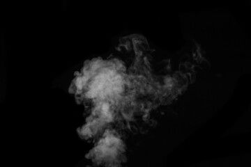 Fragment of white hot curly steam smoke isolated on a black background. Create mystical Halloween...