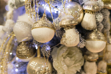 Close up of holidays location with toys and garlands on blue white Christmas tree