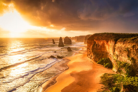 Scenic view of sea against cloudy sky at Twelve Apostles Marine National Park during sunset, Victoria, Australia