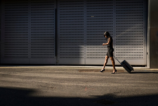 Businesswoman with trolley checking the time