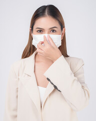 portrait of young businesswoman wearing a surgical mask over white background studio