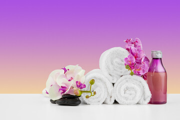 Beautiful pink flowers and white towels on pink background