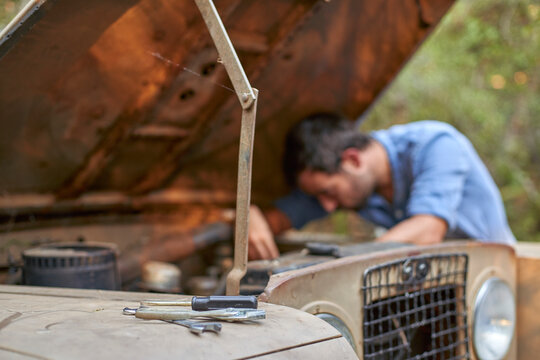Man with old car having a breakdown
