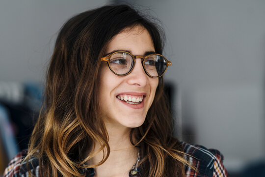 Portrait of laughing young woman wearing glasses