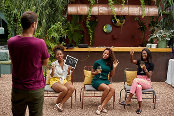 Three young women rating a man, having fun