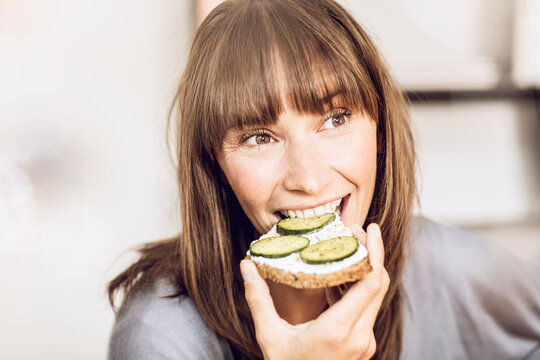 Mature woman eating healthy cucumber bread
