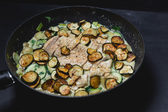 Chicken Zucchini Potato Stew with creme fraiche in a pan