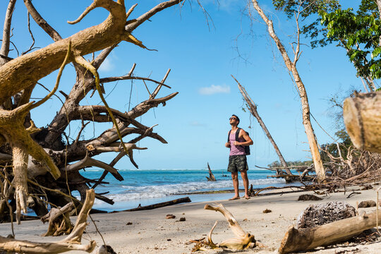 Tourist with backpack standing on a tropical beach, Cahuita National Park, Costa Rica