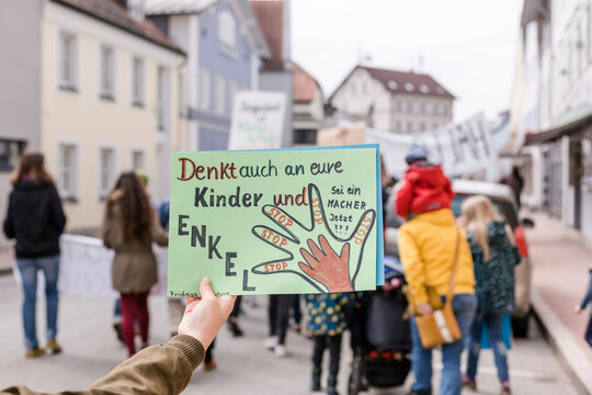Hand holding a placard on a demonstration for environmentalism