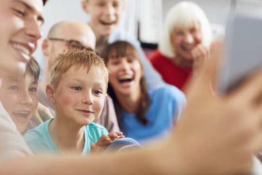 Little boy watching digital tablet with his family