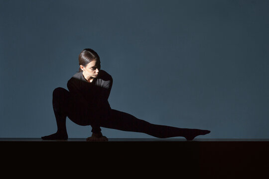 Woman dressed in black doing stretching exercise