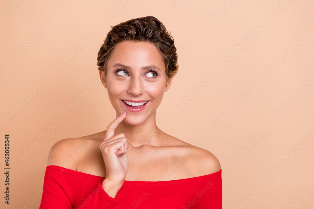 Poster Photo of amazed excited happy young charming lady imagine look empty space plan isolated on beige color background