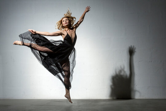 Blond woman dancing in black dress