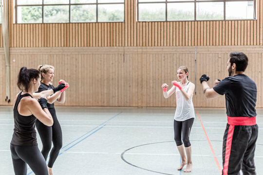 Group of boxers warming up in sports hall