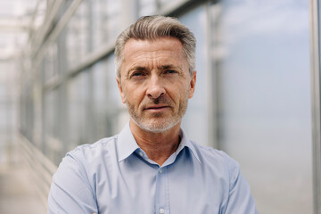 Close-up of confident male professional in plant nursery