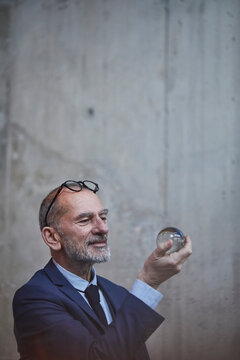 Senior businessman looking at crystal ball