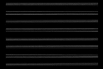 The background of a blank sheet of music is black. Abstract simple background.