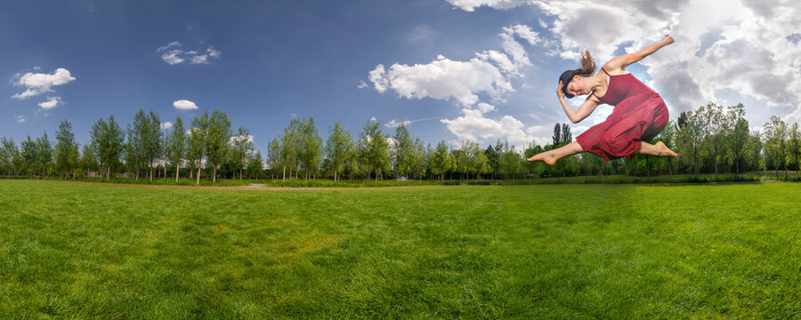 Young woman jumping on meadow