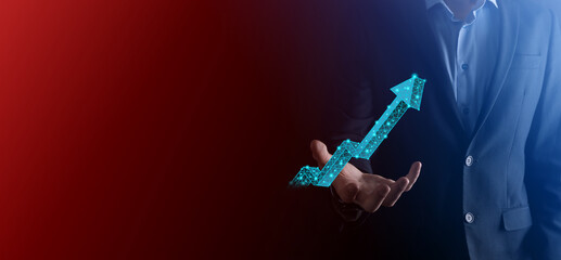 Businessman hold graph, arrow of positive growth icon.pointing at creative business chart with upward arrows.Financial, business growth concept.Low polygonal.increased sales, or increased value