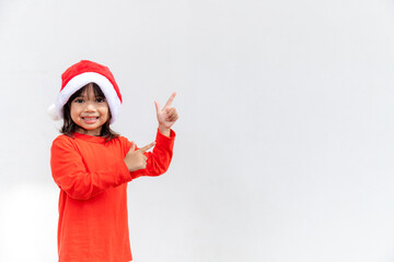 Asian little girl in red Santa hat on white background.