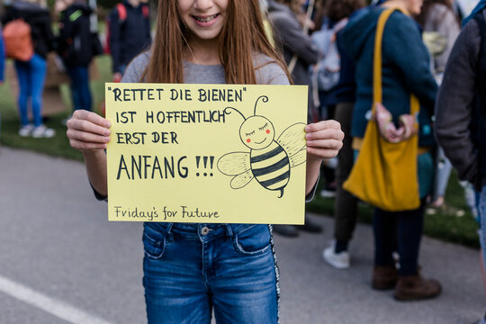 Girl holding a placard on a demonstration for environmentalism