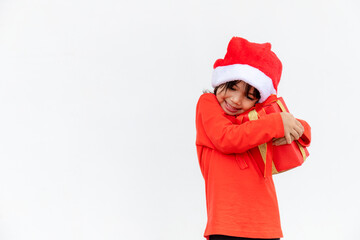 Happy Asian child in Santa red hat holding Christmas presents. Christmas time.on white background.