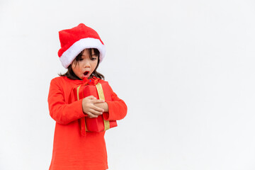 Happy Asian child in Santa red hat holding Christmas presents. Christmas time.on white background.