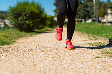 Close-up of woman running on stony path