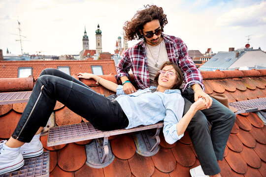 Young couple relaxing on rooftop