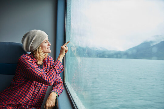 Chile, Hornopiren, woman drawing a heart on the window of a ferry