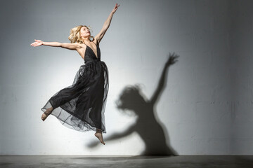 Blond woman dancing in black dress