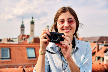 Young smiling woman taking picture