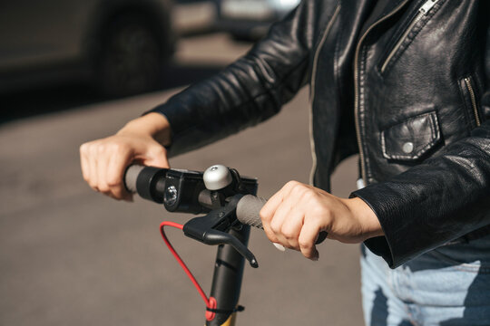 Hands on handlebar of scooter, close-up - Powered by Adobe