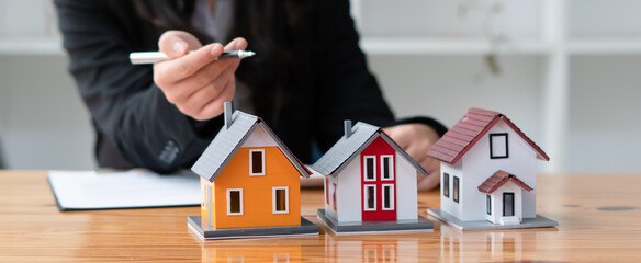 The real estate agent is explaining the house style to the clients who come to contact to see the...