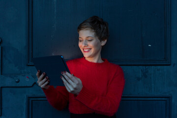 Portrait of smiling businesswoman using digital tablet at twilight