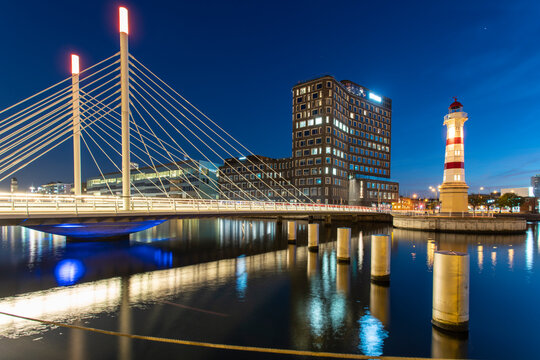 Illuminated bridge over river against sky in Malmo, Sweden
