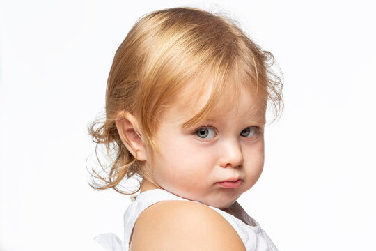 Portrait of pouting blond girl, white background