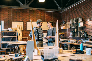 Carpenters at work on wooden table