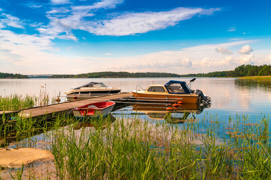 Boats moored in river at jetty in Loftahammar, Sweden