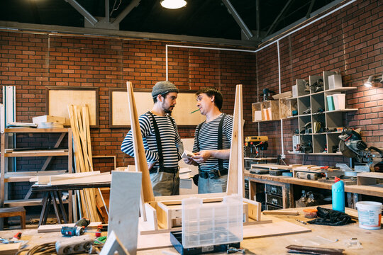 Carpenters at work on wooden table
