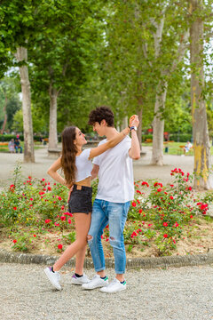 Young couple dancing in a park